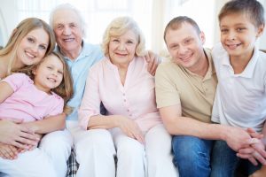 Portrait of senior and young couples with their children looking at camera at home