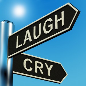 Laugh Or Cry Directions On A Metal Signpost